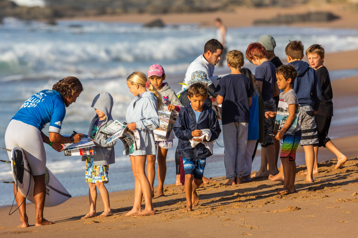 Kids frothing about collecting autographs in their Ballito Pro pres by O'Neill 2019 event magazines.
